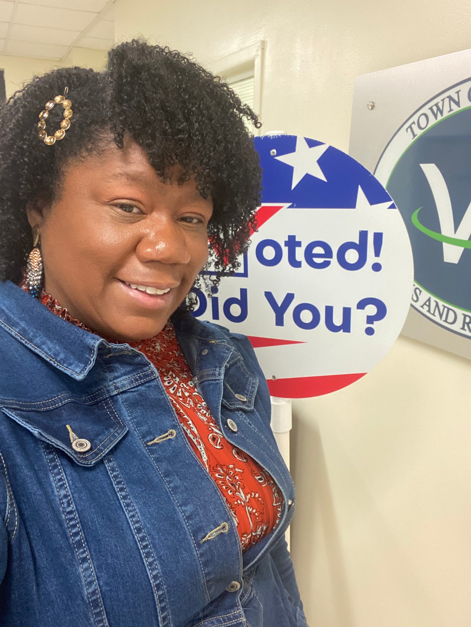 Bonnie Greaves at a polling location with an I Voted sign